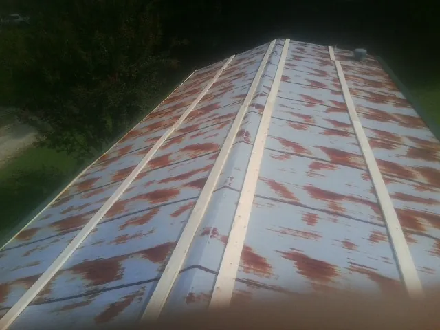 Rusted metal roof panels with new wood purlins before replacement — Storm Damage Roof Repair in La Pine by Roofing Brothers